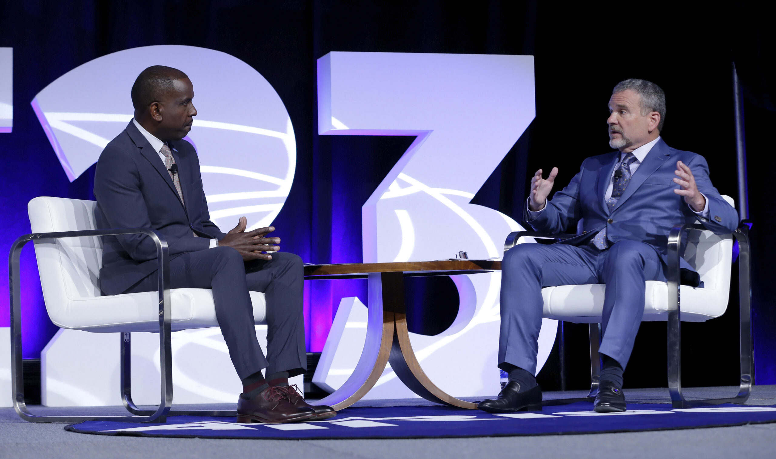 Terrence Walton, left, COO of All Rise, speaks with Doug Marlowe, right, senior scientific consultant for All Rise during the opening general session at RISE23. 