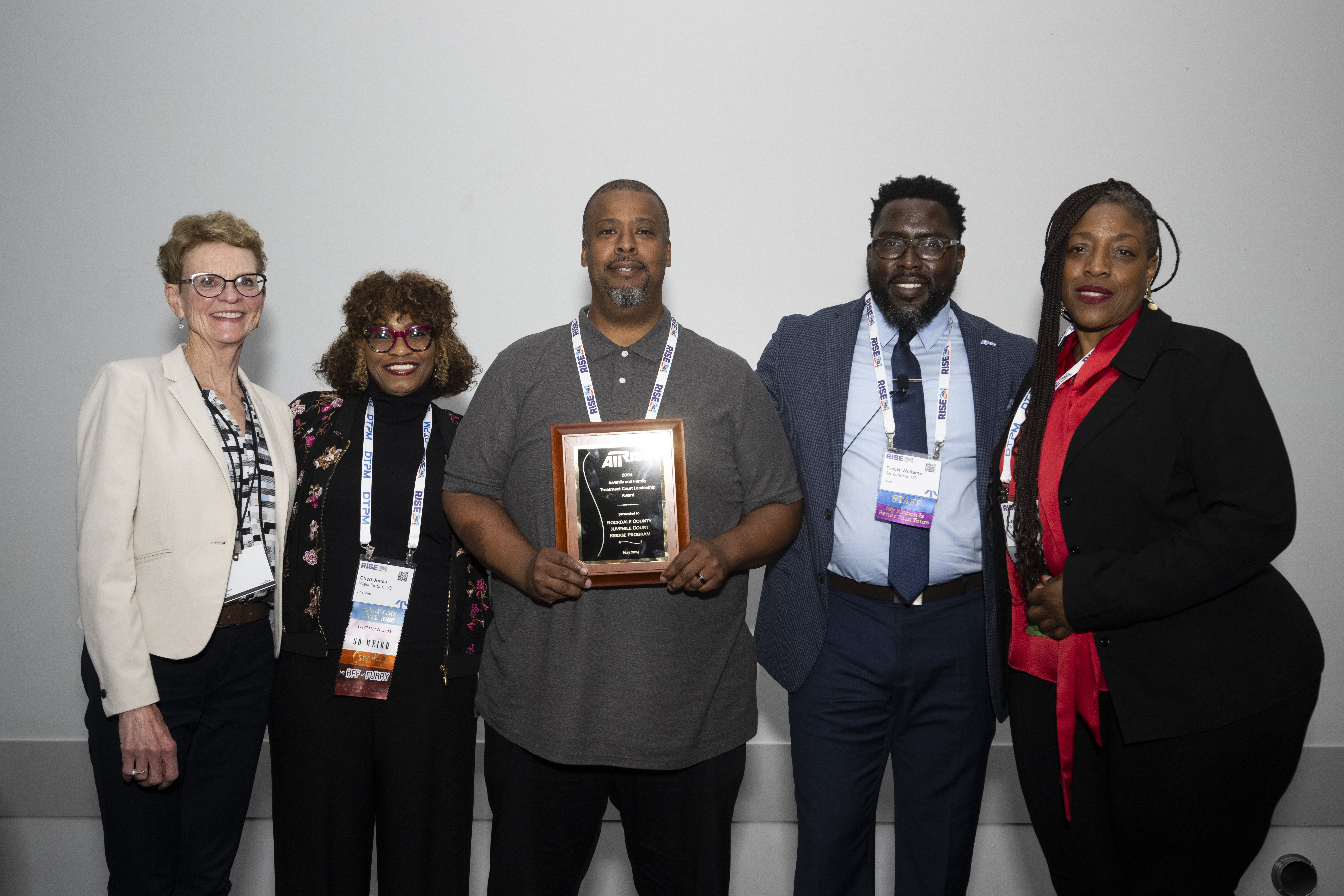 All Rise project director Travis Williams, second from right, joins the deputy administrator for programs at the U.S. Department of Justice Sharyl Jones, second from left, and deputy associate administrator for the Office of Juvenile Delinquency and Prevention Leanetta Jessie, right, to present members of the Rockdale County Juvenile Court team the Juvenile and Family Treatment Court Leadership Award.