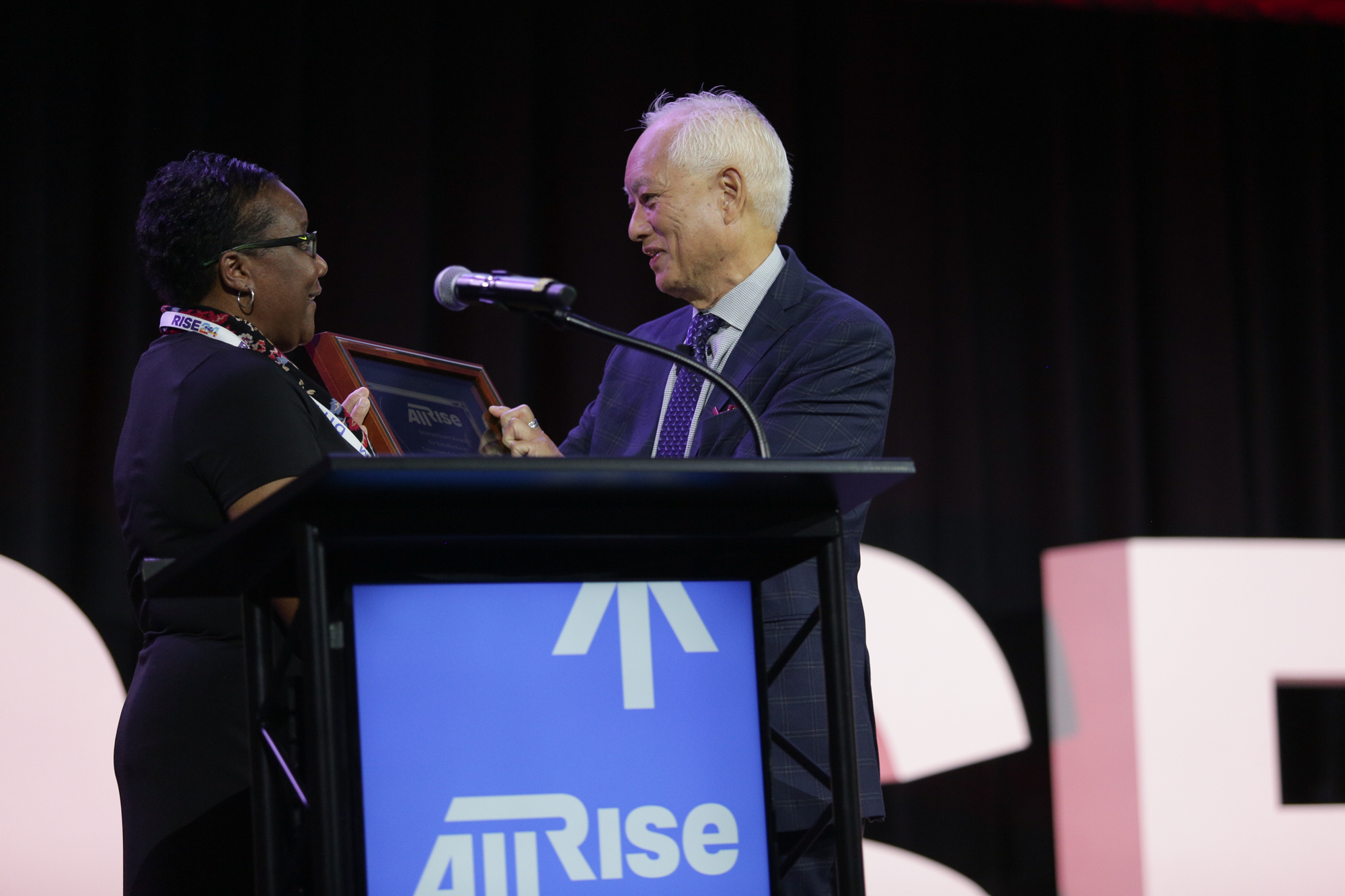 All Rise director of training and research Carolyn Hardin, left, presents the Science Giant Award to Dr. David Mee-Lee. 