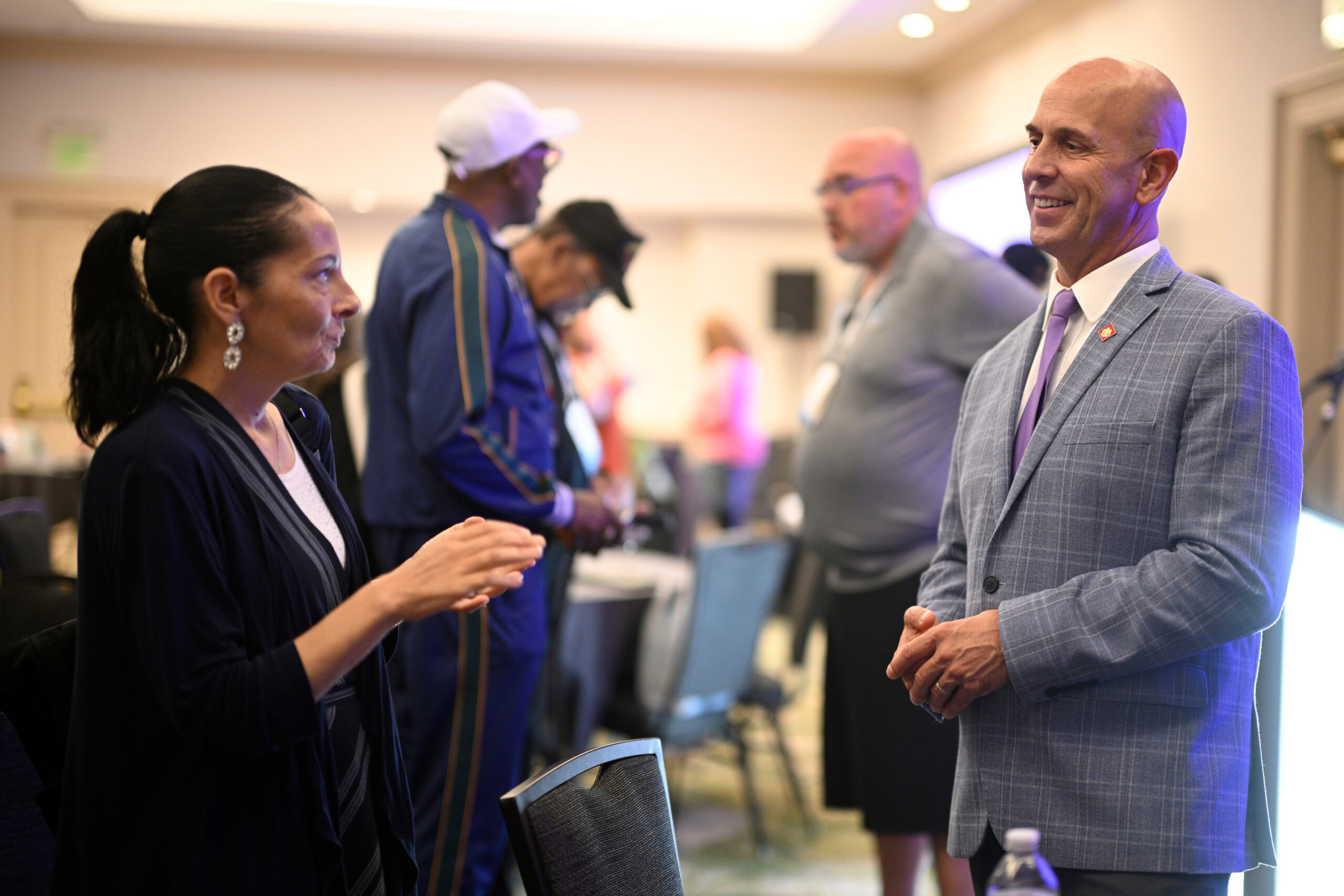 Scott Tirocchi, right, division director for All Rise's Justice for Vets, converses with an attendee after "Veteran Mentor Corps Boot Camp: Suicide Awareness and Prevention."