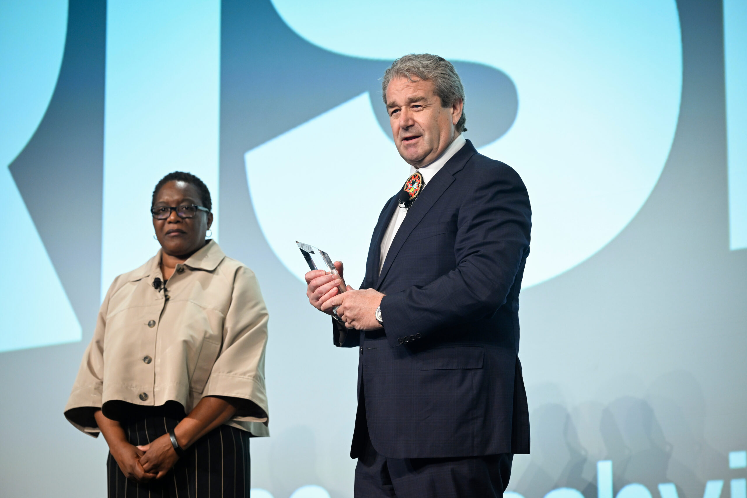 Hon. Eric Mehnert accepts his induction from All Rise Chief of Training and Research Carolyn Hardin